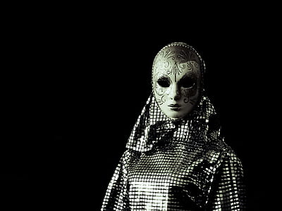 person wearing white and gray mask and dress thumbnail