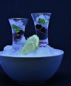two round clear glass cups filled with liquid near sliced of lemon with ice thumbnail