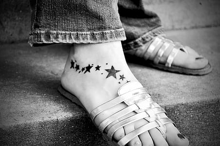 grayscale photograph of person wearing flat sandals thumbnail