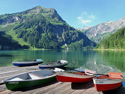 five boats beside body of water near mountain thumbnail