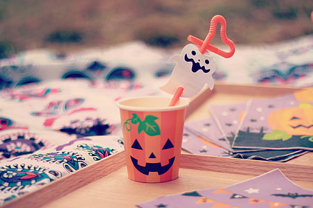 orange and white plastic cup with straw Halloween decorations thumbnail