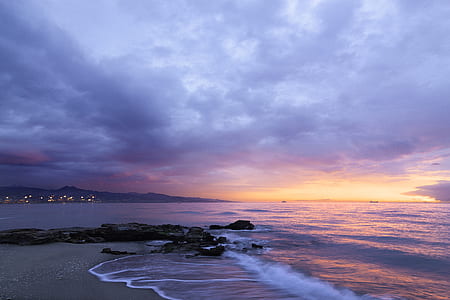 time lapse photography of white sand beach under golden hour thumbnail