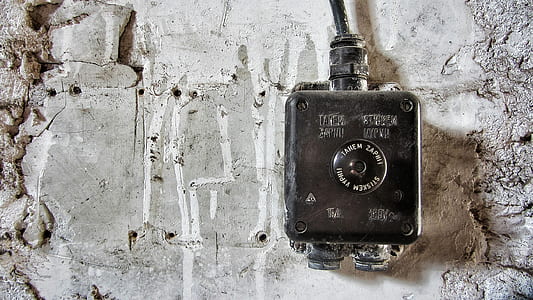 square black metal corded electronic device near white pavement thumbnail