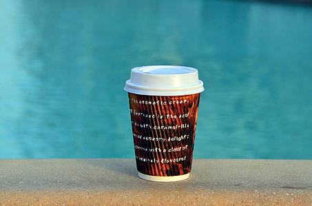 photo of white, black, and red cup near pool thumbnail