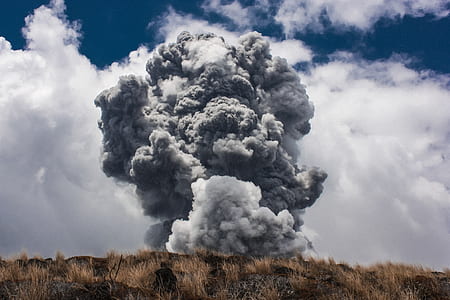 grey smoke above brown hill during daytime thumbnail
