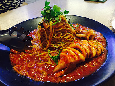 pasta with sauce and garnish on black plate thumbnail