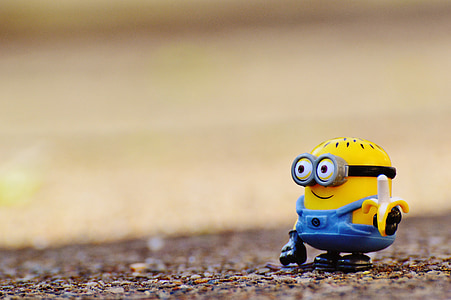 Despicable Me Minion figure on brown surface at daytime thumbnail