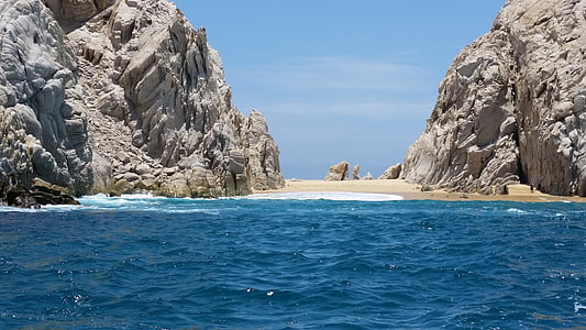 rock formation on body of water during daytime thumbnail