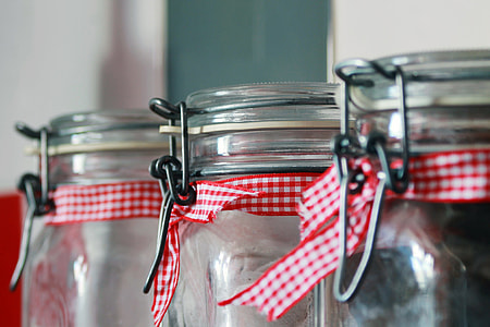 selective focus photography of three clear glass air tight canisters near wall thumbnail