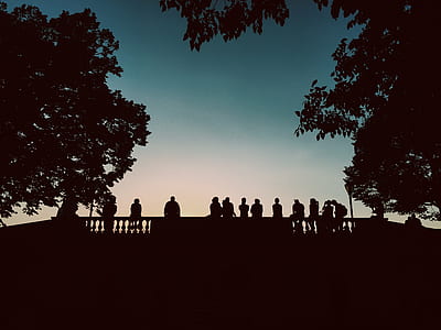 silhouette of people sitting on ledge thumbnail