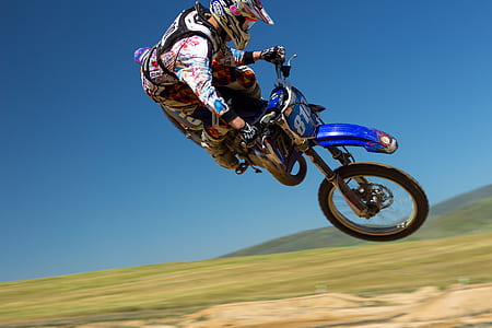 man riding motocross performing stunts during daytime thumbnail