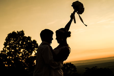 woman holding flower bouquet while hugging a man thumbnail