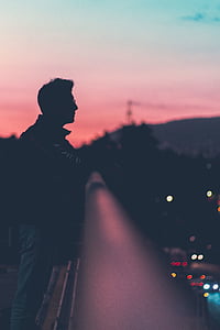 man leaning of balcony fence thumbnail