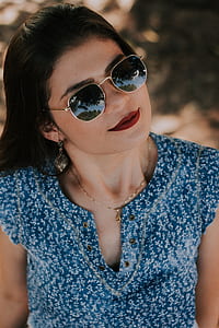 woman wearing Ray-Ban sunglasses during daytime thumbnail