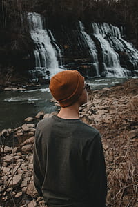 person standing on rocky shore thumbnail
