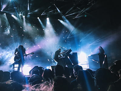 band performing on stage in front of crowd thumbnail