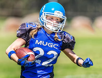 woman wearing football equipment running thumbnail