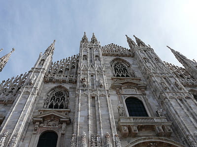 low angle photography of gray cathedral under white sky during daytime thumbnail