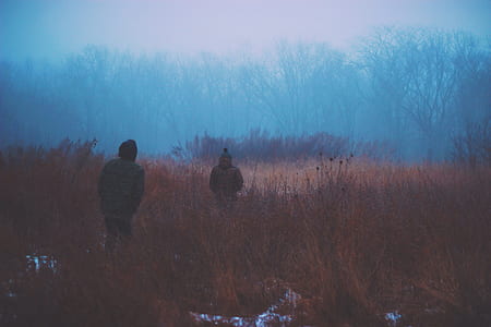 two men on brown grassland thumbnail