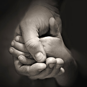grayscale photo of two person holding hands thumbnail