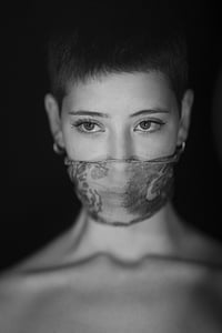grayscale photo of topless woman wearing mask thumbnail