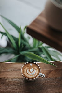 tilt shift photograph of white ceramic mug with coffee thumbnail