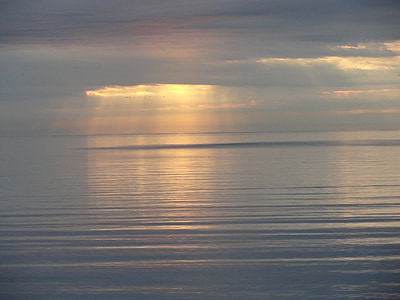 landscape photography of body of water under clouds with sun rays thumbnail