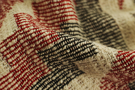 white, black, and red knit textile thumbnail