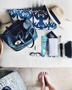 black leather handbag beside pillow on sofa thumbnail