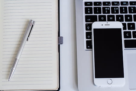 Silver Iphone 6 Near Notebook and Click Pen thumbnail