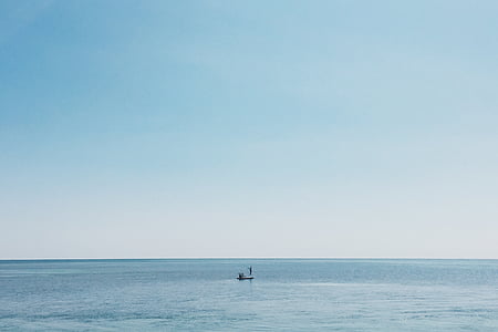 boat on calm body of water under blue and white sky at daytime thumbnail