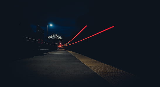 photo of red lights and concrete pathway during night time thumbnail
