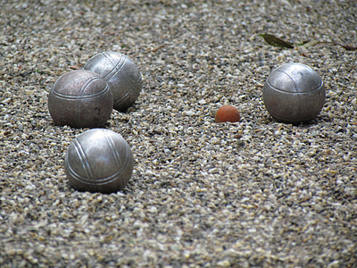 four grey metal balls on brown rocks close-up photography thumbnail