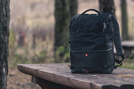 Black Backpack on Top of Wooden Table thumbnail