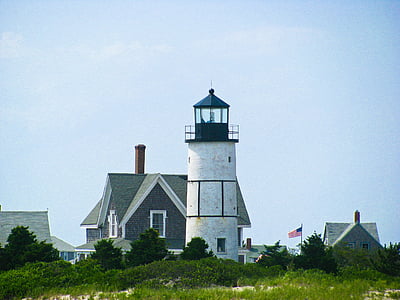 lighthouse beside flag of U.S.A. thumbnail