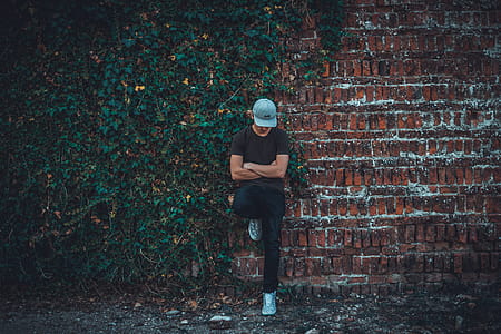 Man Leaning on Brick Wall thumbnail