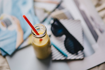 Healthy shake in a small bottle with a straw and sunglasses thumbnail