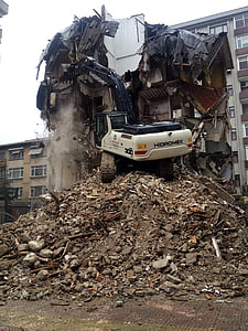 black and white excavator beside building thumbnail