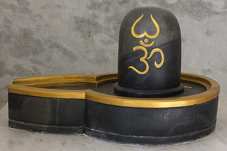 close-up photo of black and brown wooden lingam altar thumbnail