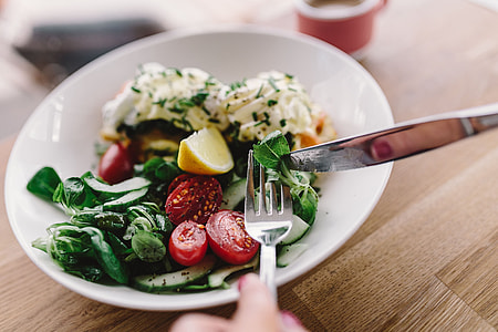 Close up image of young woman eating classic breakfast at restaurant thumbnail