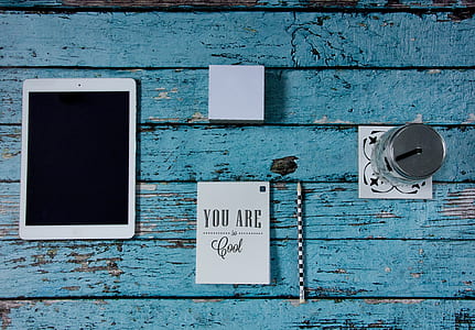 iPad beside notebook, pencil, sticky note pad, and mason jar thumbnail