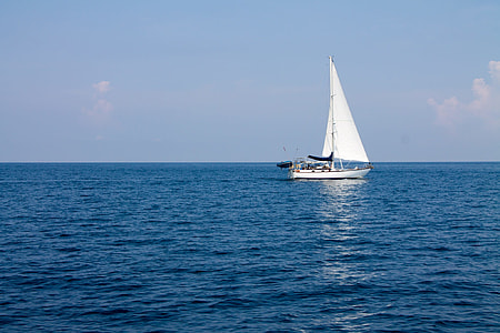 white sailboat on ocean during daytime thumbnail