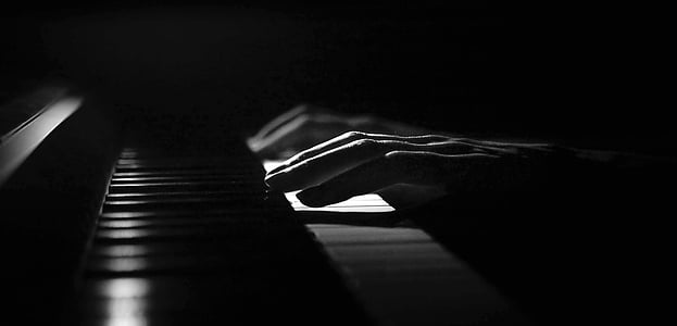 grayscale photography of person playing piano thumbnail