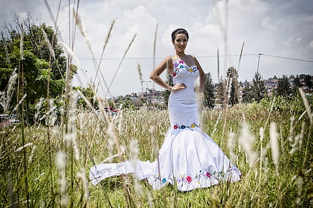 Woman Standing on Grass Field Wearing Mermaid Dress thumbnail