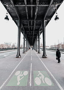 man standing on road at daytime grayscale photgraphy thumbnail