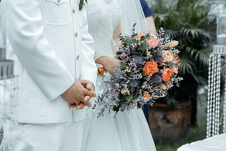 groom and bride standing near plant thumbnail