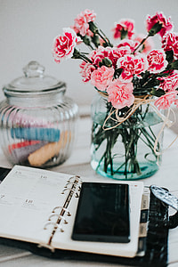 Organizer, mobile phone and lovely pink flowers thumbnail