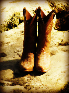 pair of brown cowboy boots thumbnail