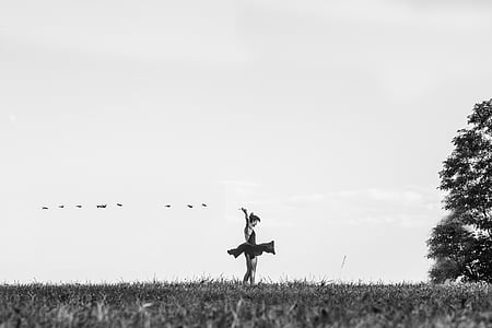 grayscale photo of woman dancing on lawn thumbnail