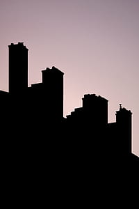 silhouette of buildings under gray skies thumbnail